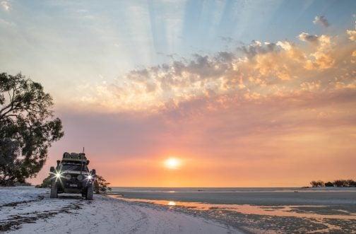 4WD car driving on beach