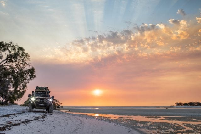 4WD car driving on beach