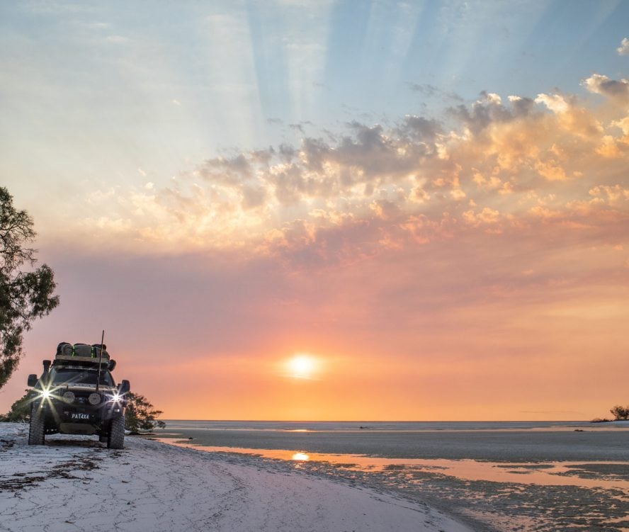 4WD car driving on beach
