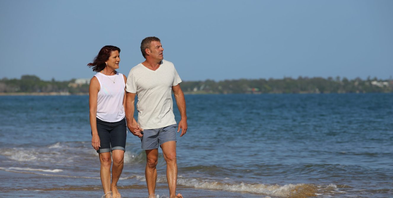 Couple walking along beach