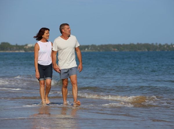 Couple walking along beach