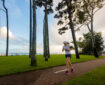 Woman running along path at Torquat Beach