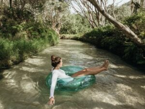 girl floating down eli creek on k'gari/fraser island